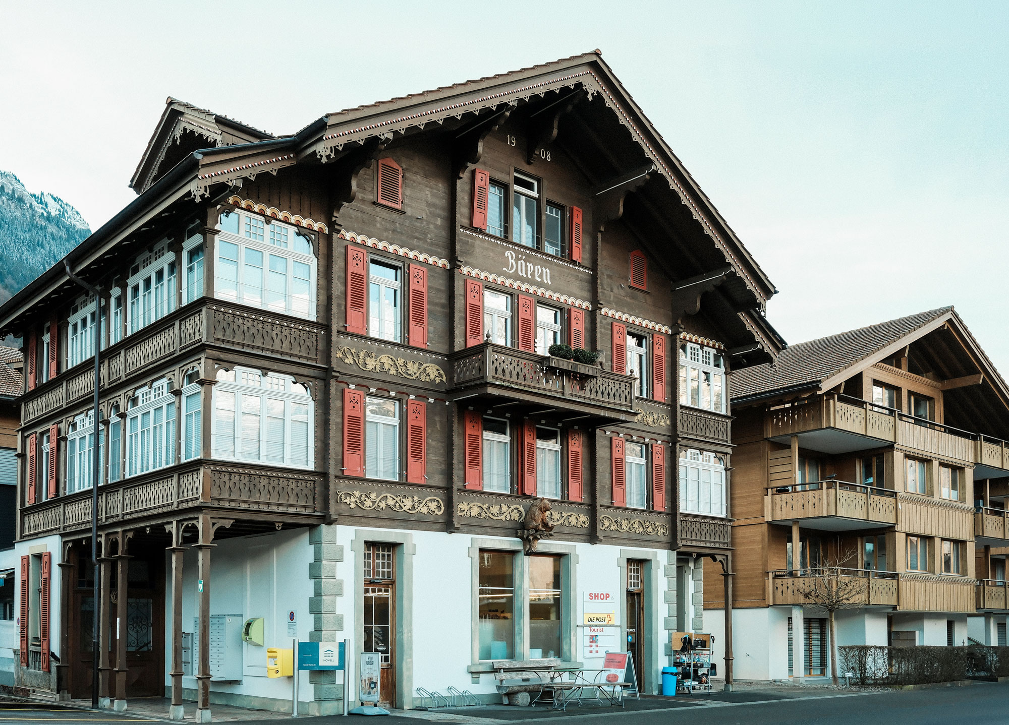 Village shop in Iseltwald with tourist information office in a traditional Swiss chalet near Lake Brienz.